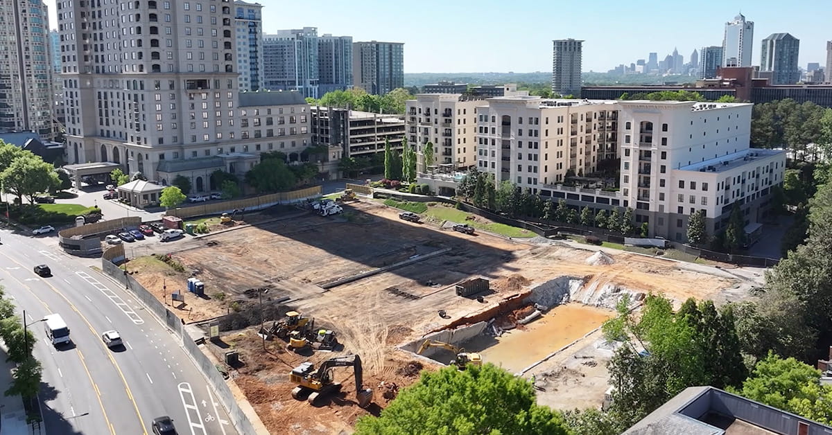 Aerial view of urban construction site with excavation and machinery