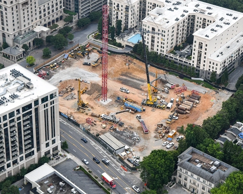 Aerial view of Elyse Buckhead construction site with cranes and surrounding buildings.
