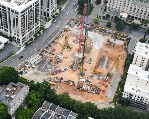 Elyse Buckhead construction site with tower cranes, equipment, and foundation activity.